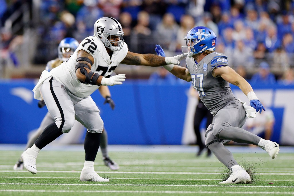 Jermaine Eluemunor #72 of the Las Vegas Raiders defends against Aidan Hutchinson #97 of the Detroit Lions in the third quarter at Ford Field on October 30, 2023.