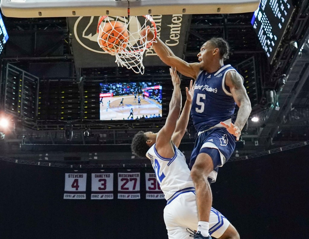 Armoni Zeigler #5 of the St. Peter's Peacocks dunks the ball during the game against the Seton Hall Pirates at Prudential Center on November 6, 2023 in Newark, NJ.