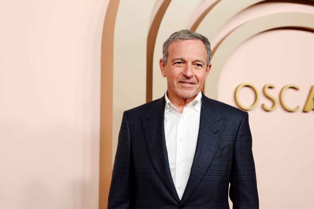 Bob Iger in a suit arriving at 2024 Oscars Nominees Luncheon Red Carpet in Beverly Hills, captured by Michael Blackshire for Los Angeles Times/Getty Images.