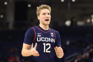 Cam Spencer #12 of the Connecticut Huskies reacts after a play during the first half in the game against the DePaul Blue Demons.