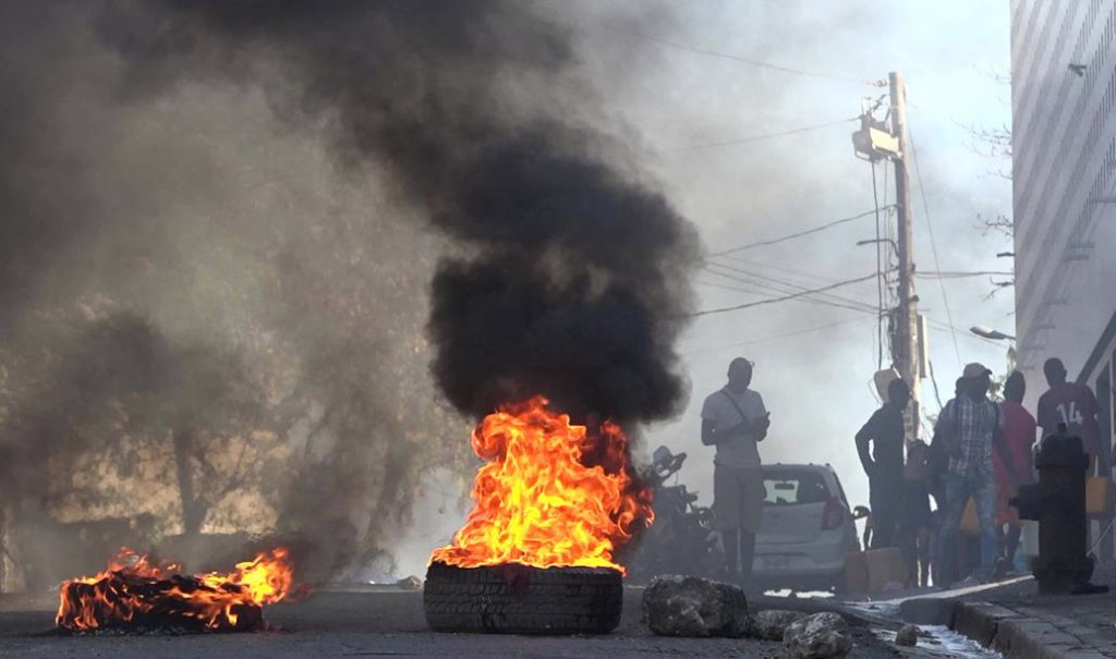 Tires are seen on fire near the main prison of Port-au-Prince, Haiti, after a breakout by several thousand inmates on March 3, 2024. 