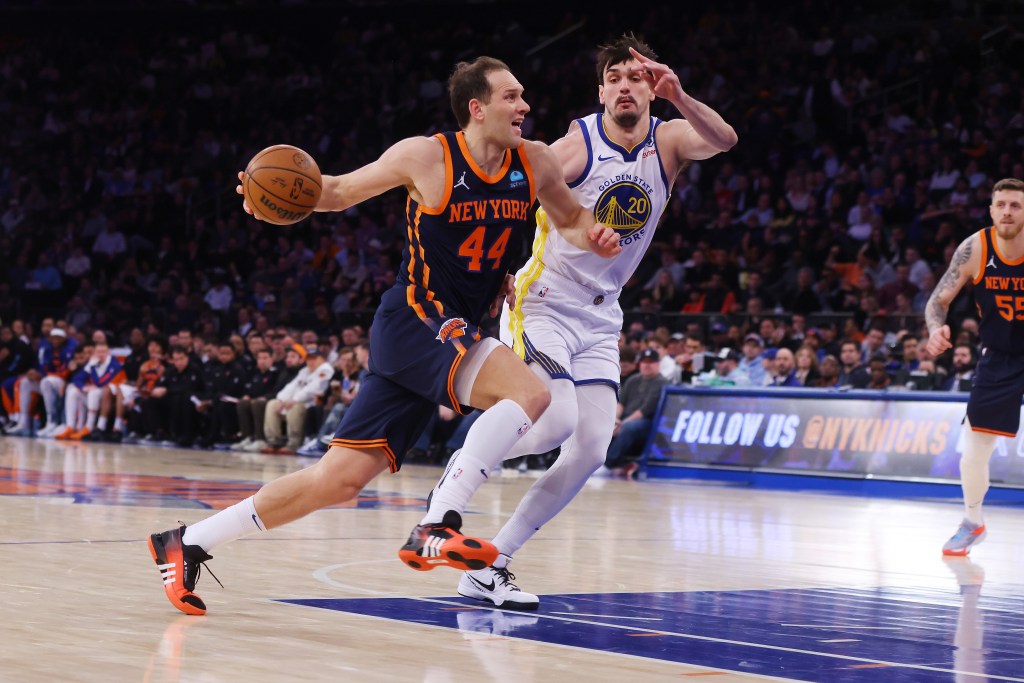 Bojan Bogdanovic #44 of the New York Knicks drives to the basket against Dario Saric #20 of the Golden State Warriors.