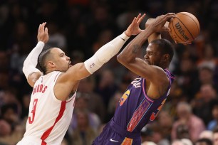 Kevin Durant #35 of the Phoenix Suns attempts to pass the ball under pressure from Dillon Brooks #9 of the Houston Rockets.