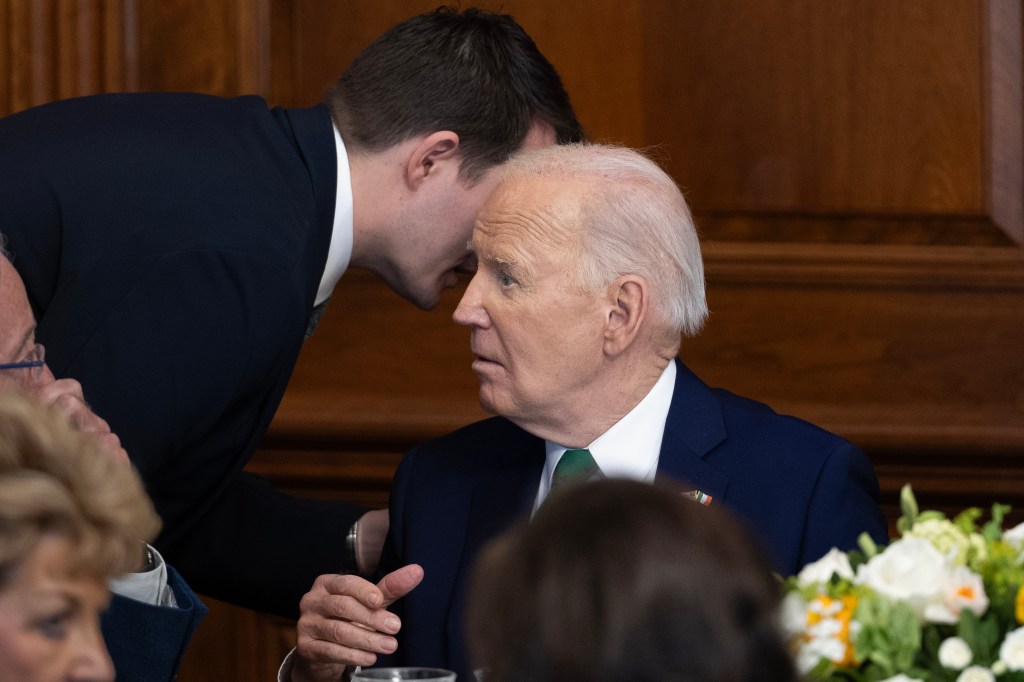 Jacob Spreyer, personal aide to U.S. President Joe Biden, speaks privately to the president during the annual Friends Of Ireland Speaker Luncheon at the U.S. Capitol on March 15, 2023 in Washington, DC.