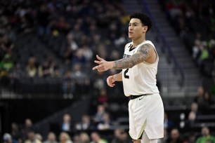 KJ Simpson #2 of the Colorado Buffaloes reacts after a 3-pointer against the Oregon Ducks.