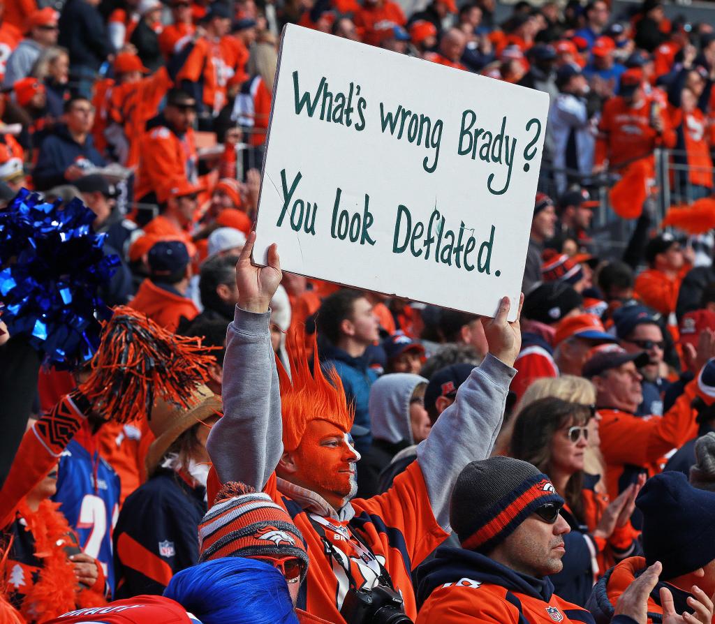 A Broncos fan taunts the New England Patriots with a deflategate sign for Tom Brady on Jan. 24, 2016, in Denver, Colorado. 