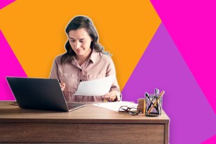 A woman sitting at a desk with a laptop and paper for H&R Block.