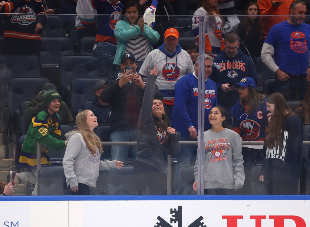 A fan throws a hat on the ice after Kyle Palmierie completed a hat trick in the first period of the Islanders' game vs. the Bruins.