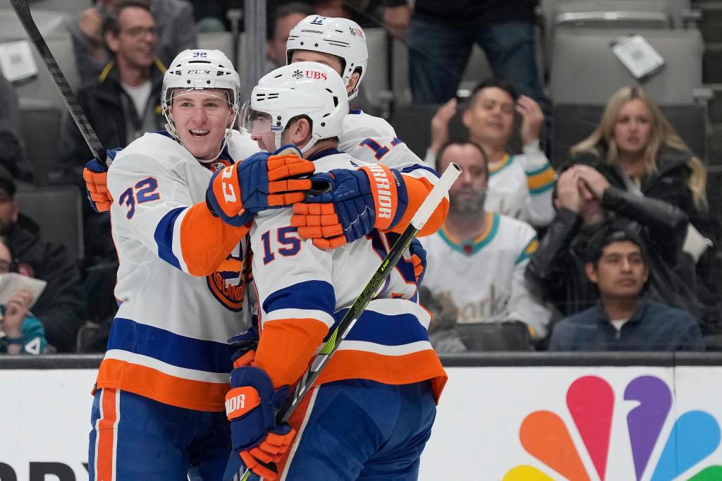 New York Islanders center Kyle MacLean, left, is congratulated by left wing Matt Martin, rear, and right wing Cal Clutterbuck (15) after scoring against the San Jose Sharks during the second period of an NHL hockey game in San Jose, Calif.