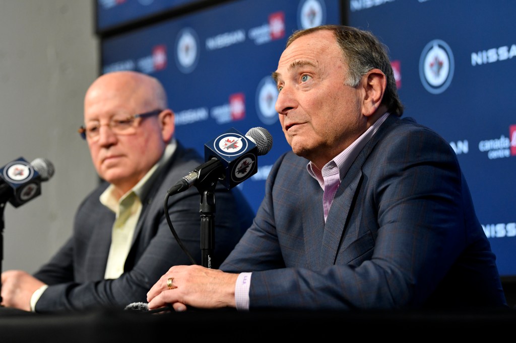 NHL Commissioner Gary Bettman, right, and Deputy Commissioner Bill Daly speak to reporters before an NHL hockey game between the St. Louis Blues and the Winnipeg Jetss on Tuesday, Feb. 27, 2024, in Winnipeg, Manitoba.