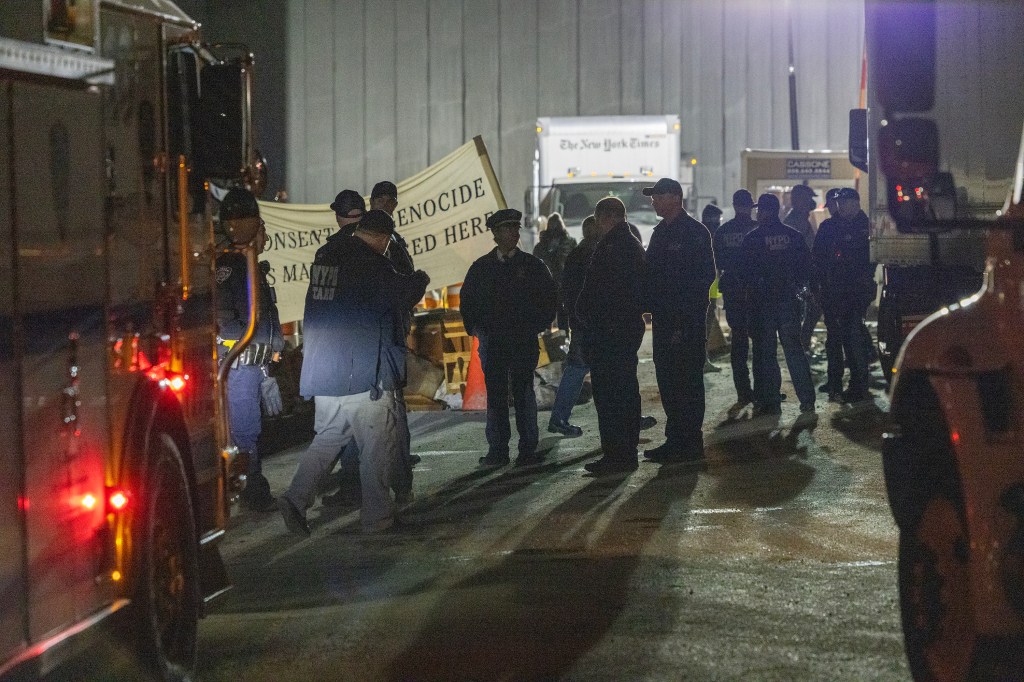 Protesters seen in the darkness if the early morning.