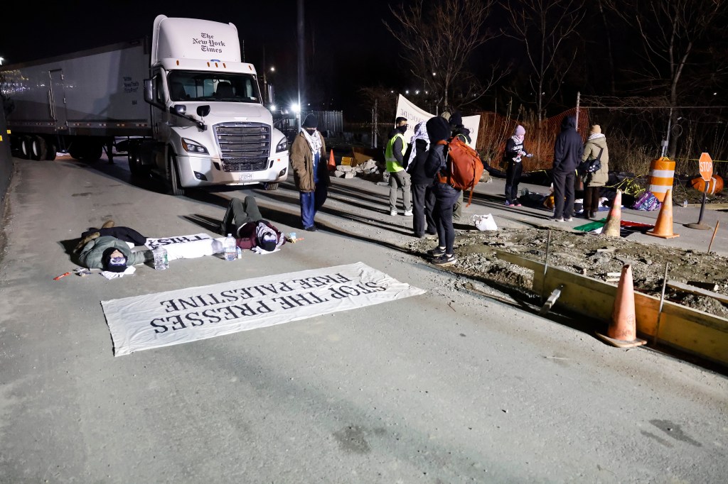 Anti-Israel protesters blocked the entrance to trucks so they could not load newspapers for delivery at the New York Times printing and offices.