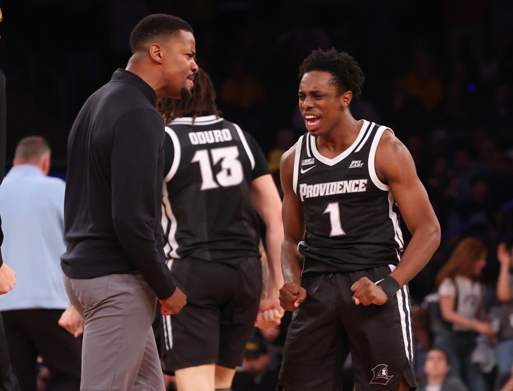 Friars coach Kim English (left) celebrates with Jayden Pierre late in the second half of Providence's upset win.