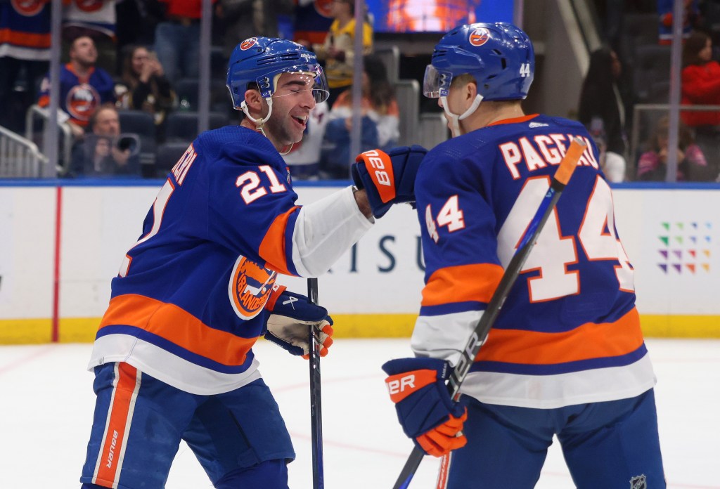 Kyle Palmieri (left) celebrates with Jean-Gabriel Pageau after completing a hat trick in the first period of the Islanders' game vs. the Bruins.