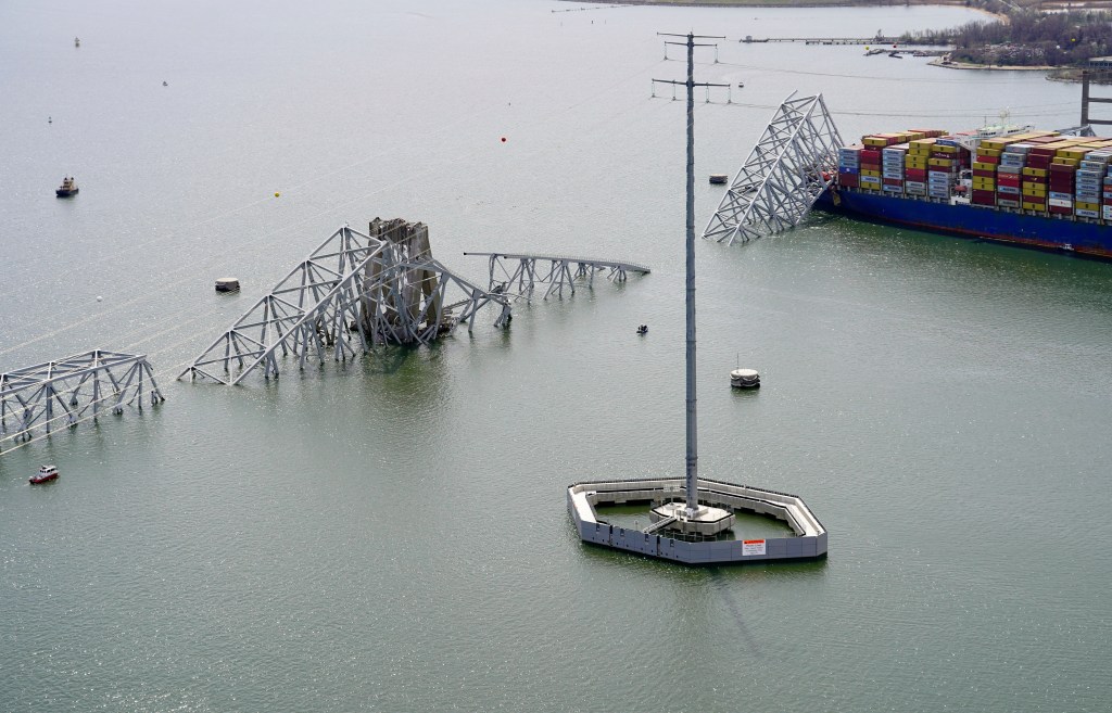 Aerial view of cargo ship Dali stuck under the partially collapsed Francis Scott Key Bridge in Baltimore, released by the Maryland National Guard