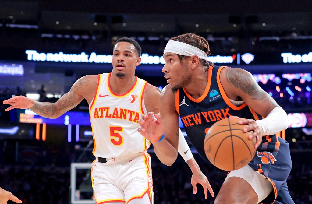 Miles McBride, who scored 11 points and added nine assists, drives past Dejounte Murray during the Knicks' loss.