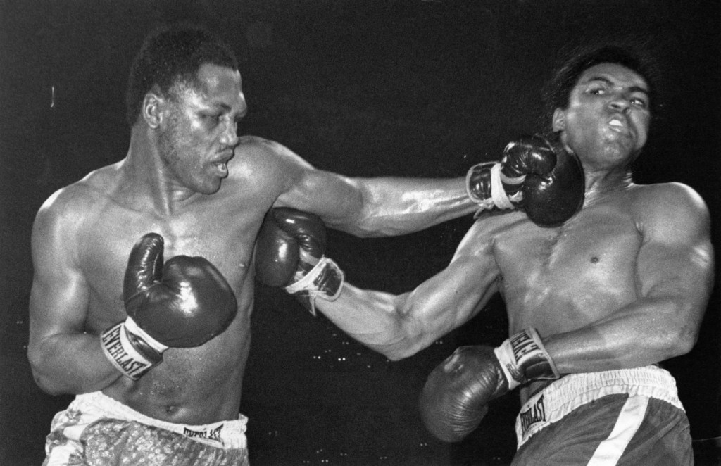 Joe Frazier delivers a stiff jab to Muhammad Ali's face during the first of their three legendary fights.