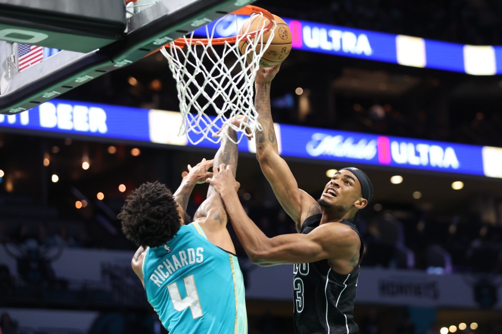 Nic Claxton, who scored 14 points, scores a bucket over Nick Richards during the Nets' loss.