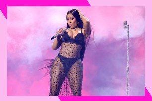 Nicki Minaj touches her hair while performing in concert.