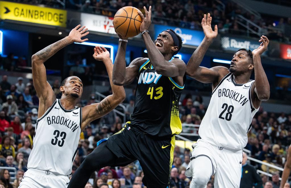 Pascal Siakam, who scored a game-high 28 points, puts up a shot between Nic Claxton (left) and Dorian Finney-Smith during the Nets' loss.