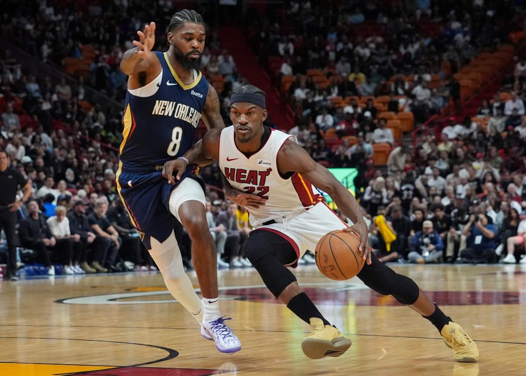 New Orleans Pelicans forward Naji Marshall (8) defends Miami Heat forward Jimmy Butler (22) during the first half of an NBA basketball game, Friday, March 22, 2024, in Miami. 