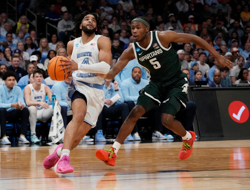 RJ Davis, who scored a team-high 20 points, drives past Tre  Holloman during North Carolina's 85-69 win over Michigan State in the Round of 32 of the NCAA Tournament.