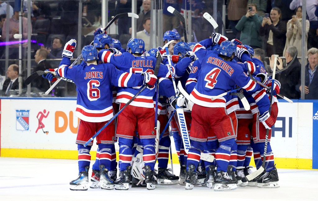 The Rangers mob Adam Fox after his game-winning OT goal gave the Blueshirts a 6-5 win over the Flyers and also clinched a playoff berth.