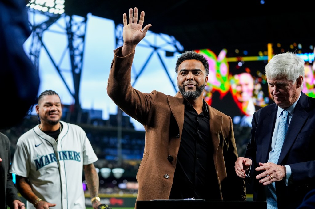 Former Seattle Mariners player Nelson Cruz waves after signing a one-day contract to retire as a Mariner, before the tema's opening-day baseball game against the Boston Red Sox, on March 28, 2024, in Seattle.