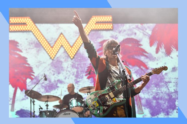 Weezer frontman Rivers Cuomo rocks out onstage.