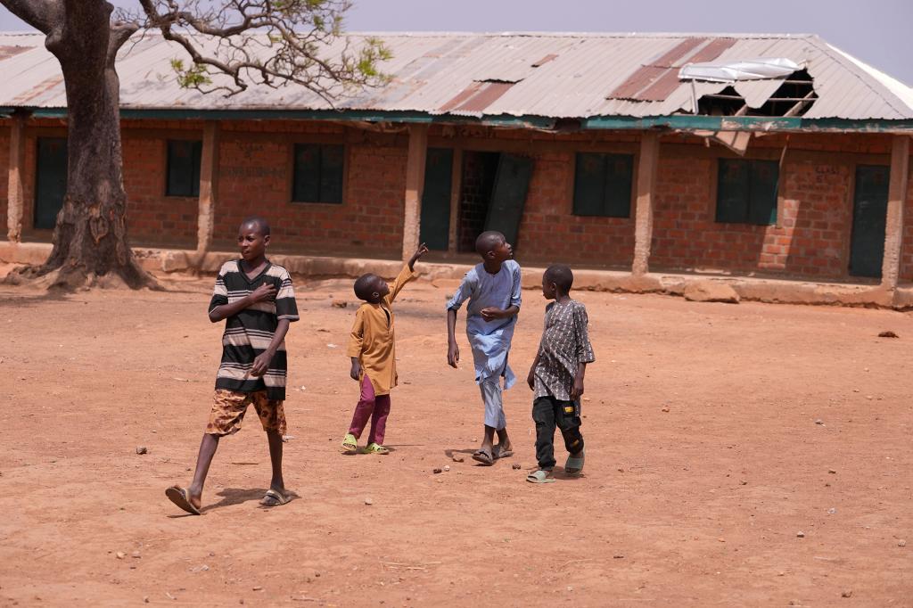 Children walk past classrooms at the LEA Primary and Secondary School 