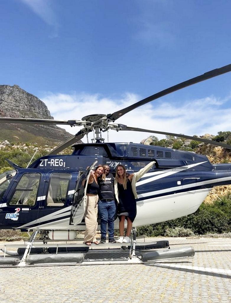 Paige Goldstein (right) and Chantel Wright (left), took their apartment doorman on a helicopter ride over Cape Town, South Africa.