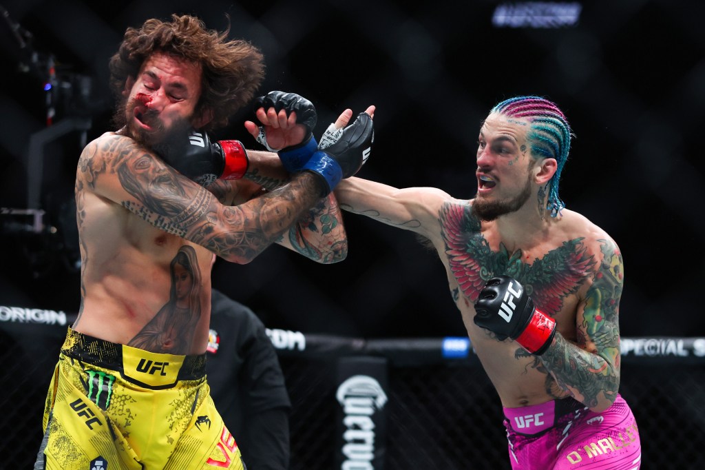 Sean O'Malley punches Marlon Vera during his win in the UFC 299 bout.