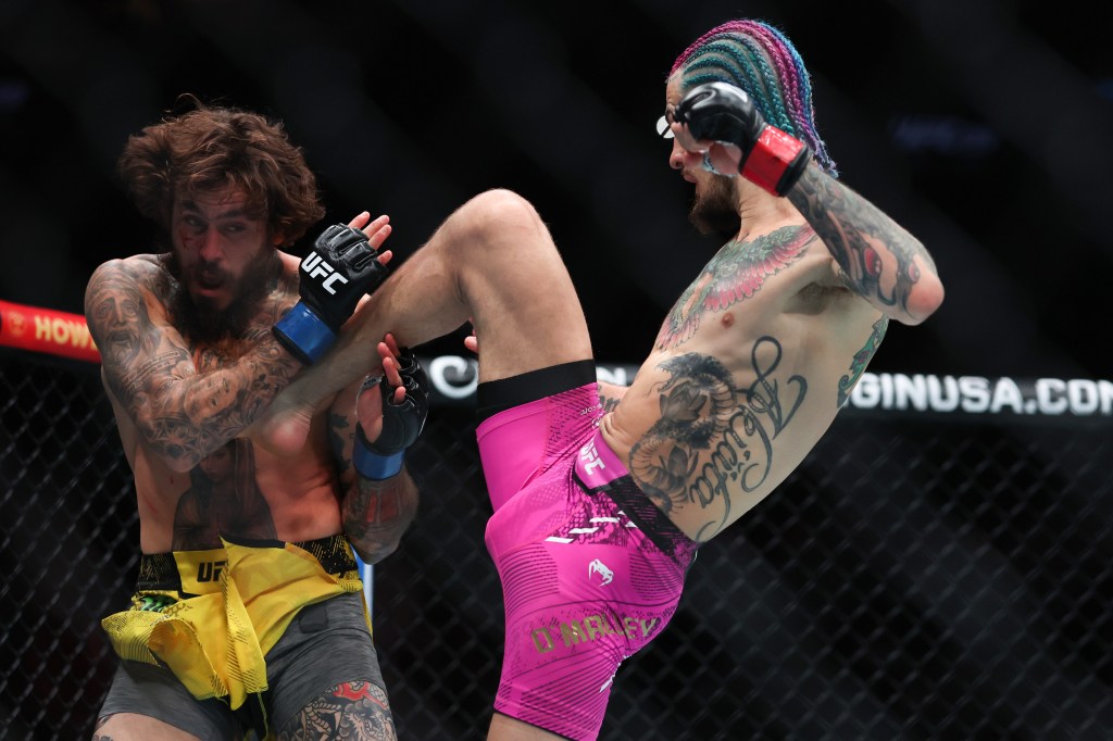 Sean O'Malley delivers a knee to Marlon Vera during his victory in the UFC 299 bout.