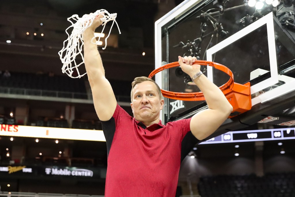 Iowa State Cyclones head coach T.J. Otzelberger cuts down the nets after winning the Big 12 tournament final against the Houston Cougars.