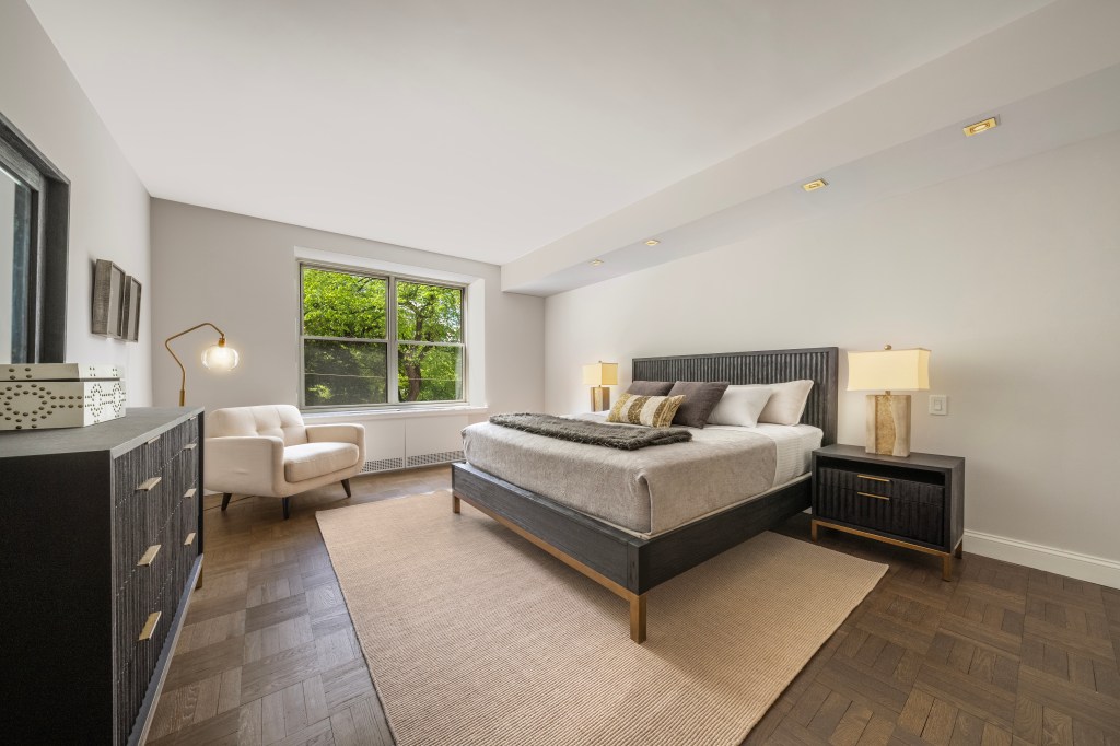 A bedroom in 'The Fifth' at 812 Fifth Avenue with a bed and chair - Courtesy of estate. Photo by Michael Weinstein, MW Studio.