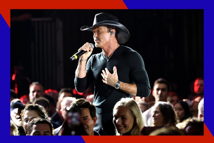 Tim McGraw sings from the crowd with fans nearby.