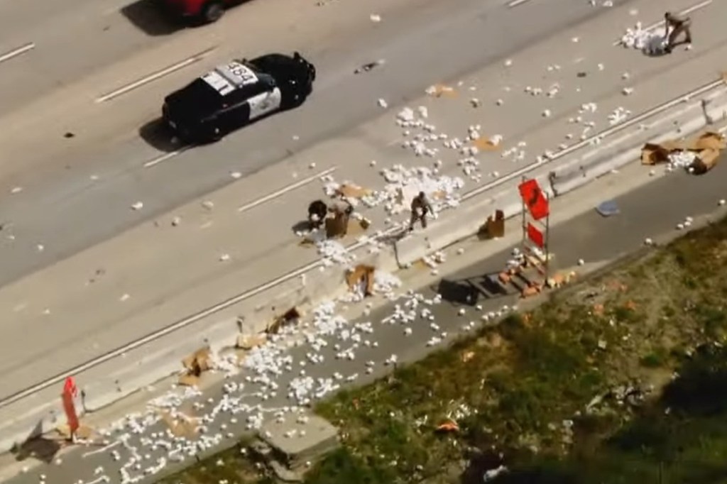 The hundreds of rolls "clogged" the freeway for hours and blocked two lanes of traffic, according to authorities. 