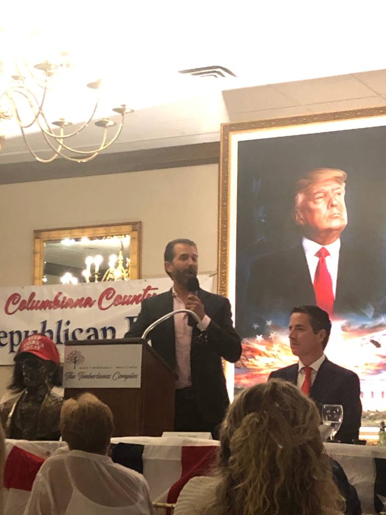 Donald Trump Jr. speaking at a podium during the annual Lincoln Day Dinner in Salem.