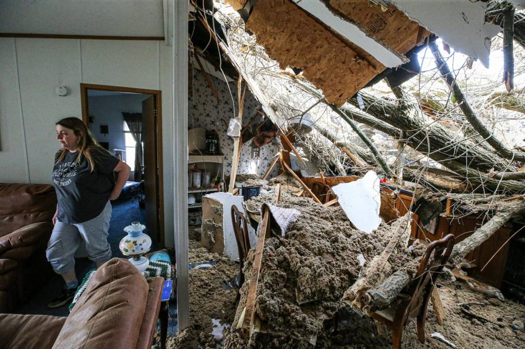 A tree is seen inside the home of Jessie Perez after it collapsed during Thursday's tornado.