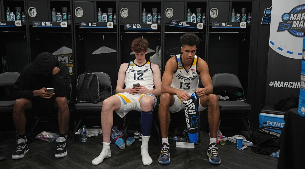 Marquette forward Ben Gold (12) and forward Oso Ighodaro (13) sit on their locker room after their loss in the semifinals of the South Regional of the 2024 NCAA Men's Basketball Tournament