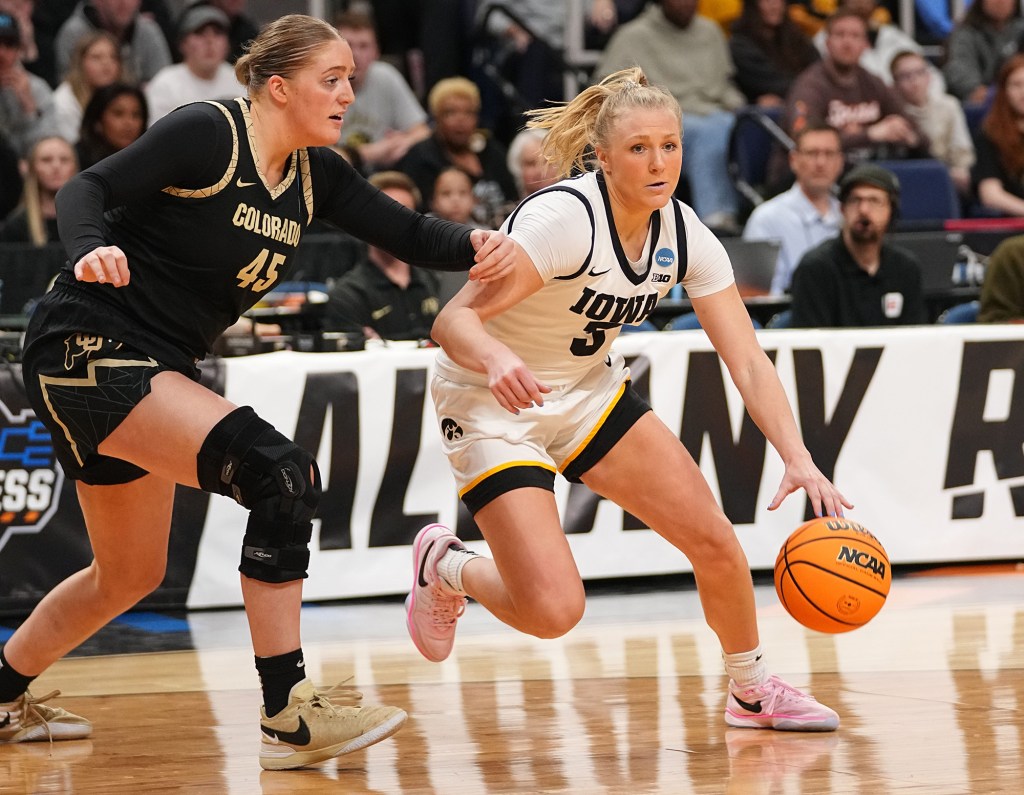 Iowa Hawkeyes guard Sydney Affolter (3) drives to the basket as Colorado Buffaloes forward Charlotte Whittaker on Saturday.