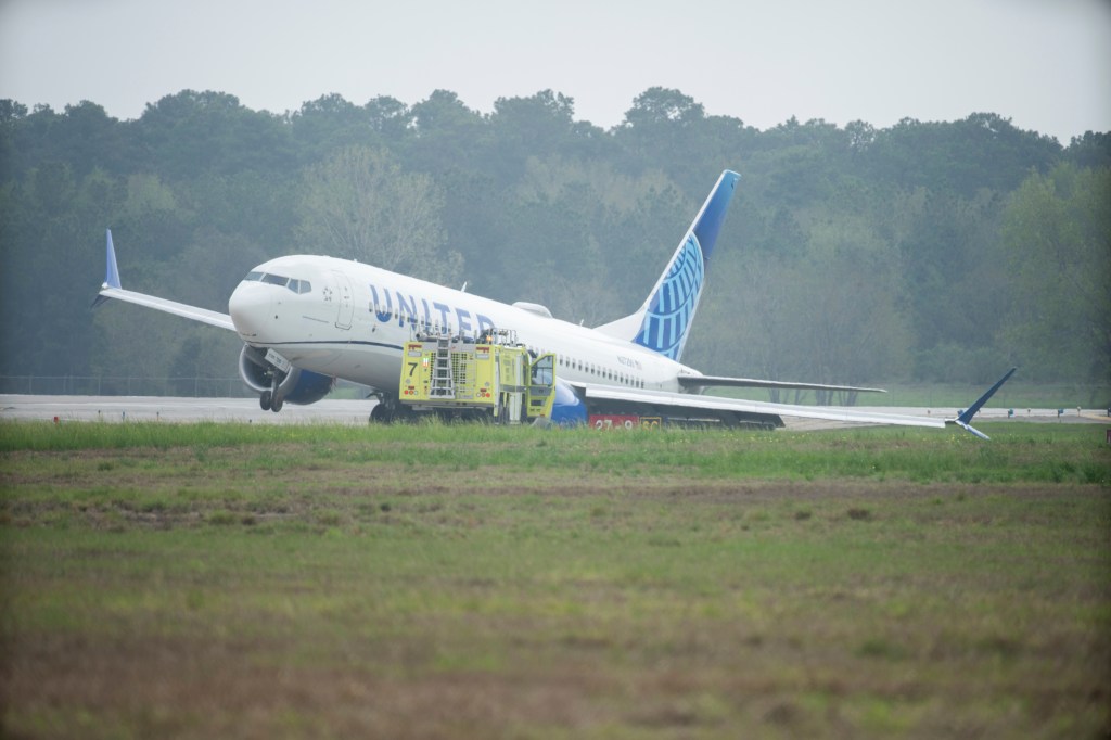 A United Airlines jet sits in a grassy area after leaving the taxiway Friday, March 8, 2024, at George Bush Intercontinental Airport in Houston.