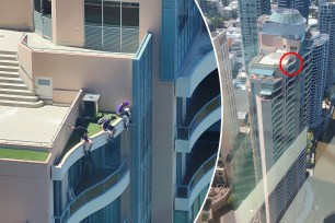 Teen boys dangle from top of 37-storey Brisbane CBD high-rise in hair-raising footage