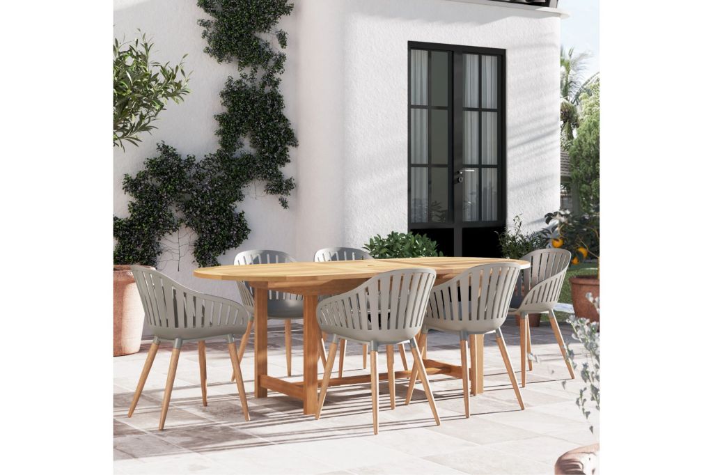 An oval shaped outdoor dining table surrounded by six chairs