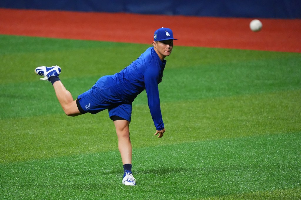 Yoshinobu Yamamoto #18 of the Los Angeles Dodgers warms up prior to the Los Angeles Dodgers workout at Gocheok Sky Dome.