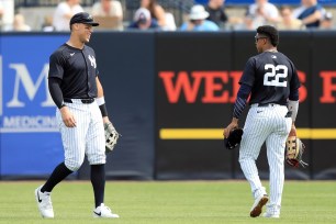 New York Yankees outfielders Aaron Judge (99) and Juan Soto (22) talk as they walk out to the outfield during the spring training game between the Tampa Bay Rays and New York Yankees.