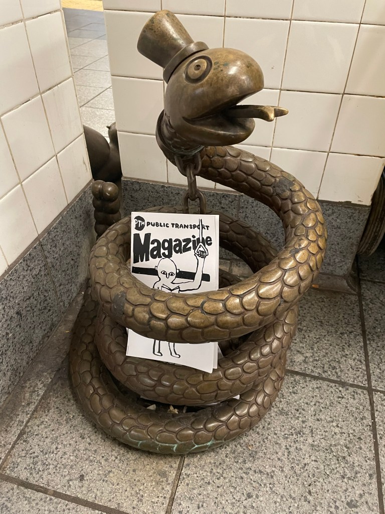 public transport magazine placed within a snake statue