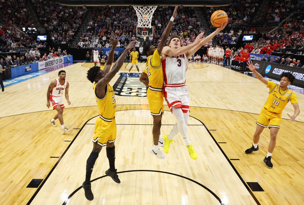 Pelle Larsson #3 of the Arizona Wildcats drives to the basket against Jadon Jones #12 of Long Beach State in the first round of the NCAA Men's Basketball Tournament.