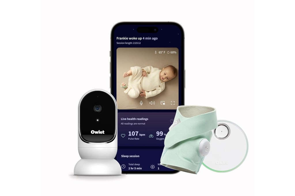 A smartphone with a baby monitor and a baby's arm.