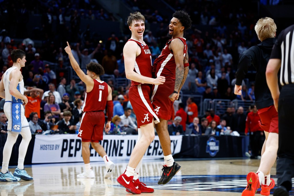 Grant Nelson #2, Aaron Estrada #55 and Mark Sears #1 of the Alabama Crimson Tide celebrate after defeating the North Carolina Tar Heels during the second half in the Sweet 16 round of the NCAA Men's Basketball Tournament.